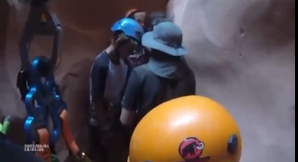 View from TFO helmet cam shows people in slot canyon waiting to be rescued